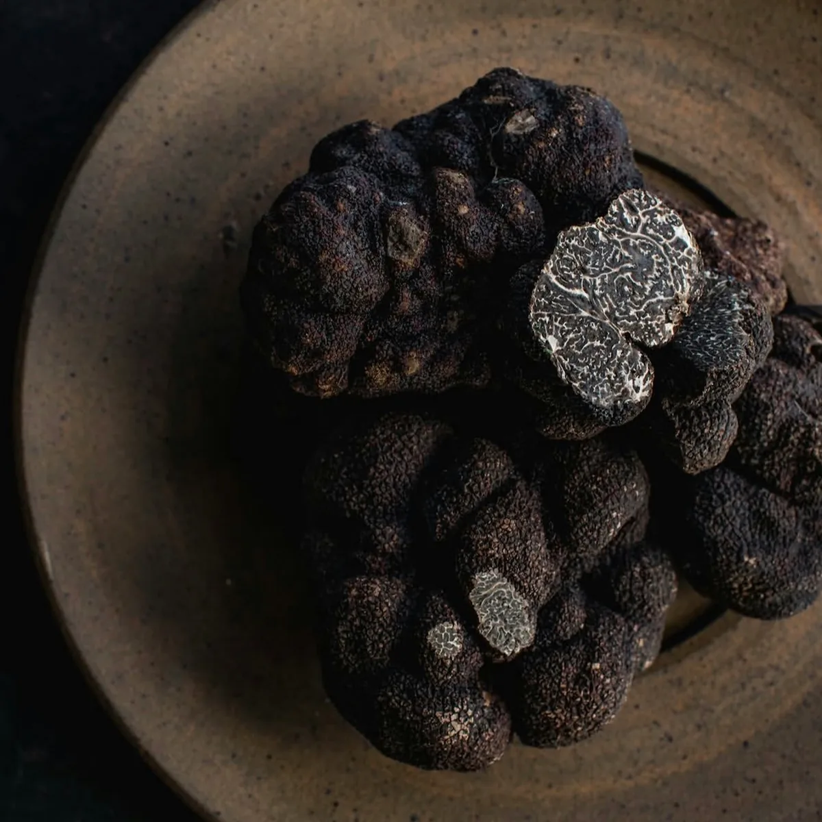 Black truffles in a ceramic bowl